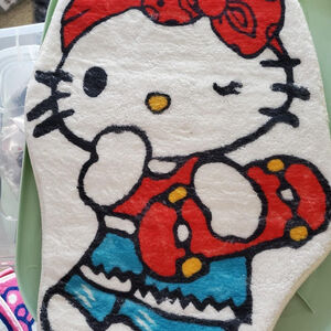 Cute Hello Kitty skateboarding design on a white and blue small mat #skaker 4x2